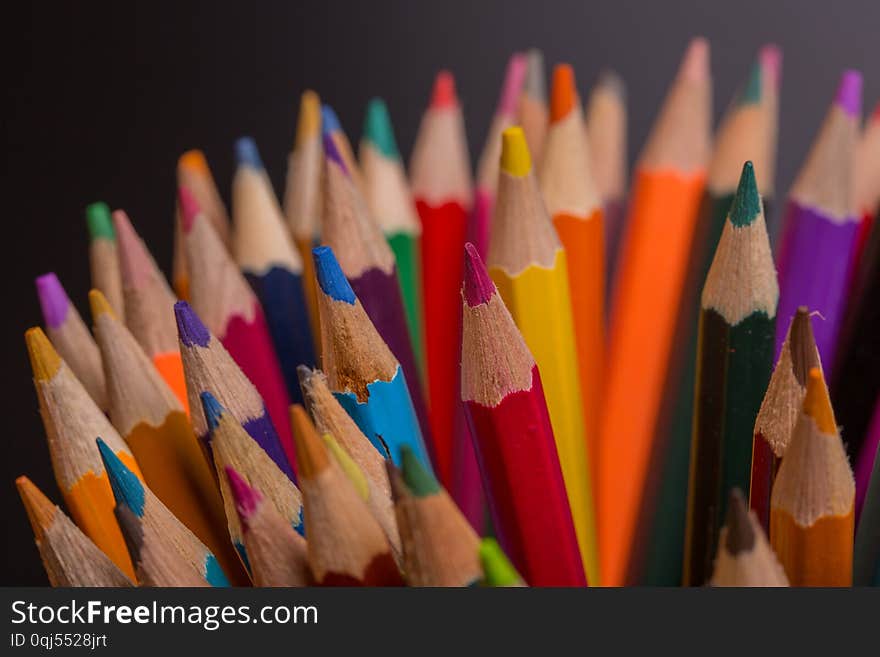 Wooden colorful pencils, on a dark background