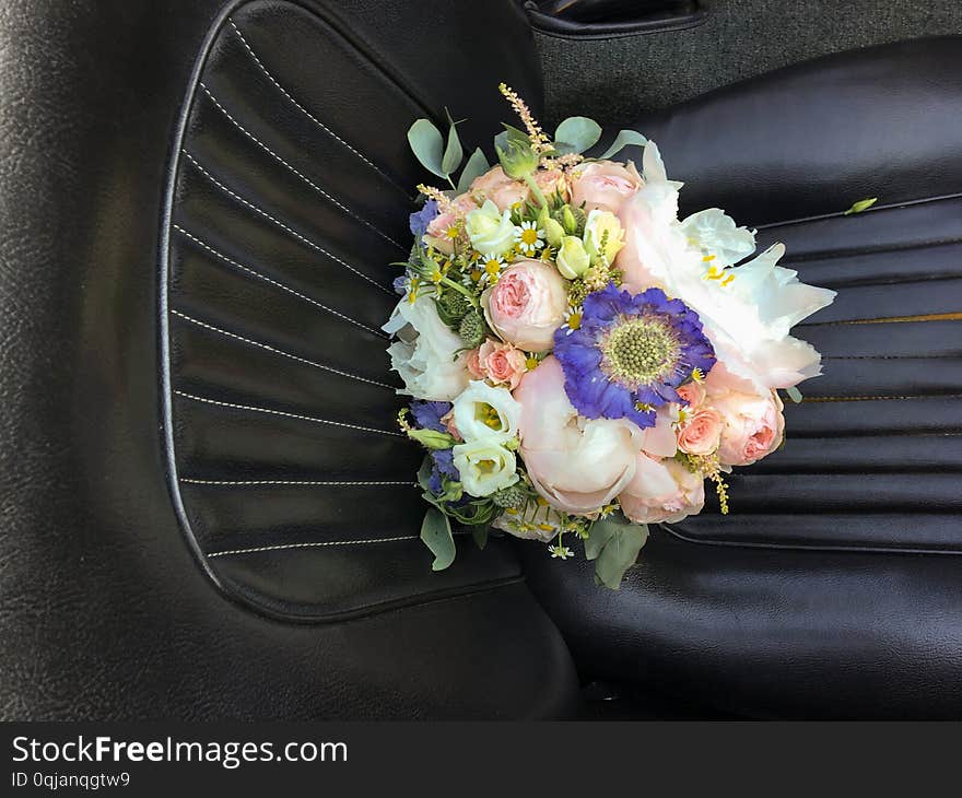 Bouquet of bridal flowers on the car seat.