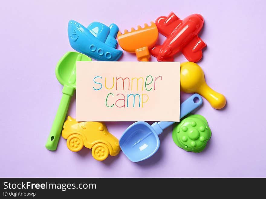 Card with text SUMMER CAMP and different sand molds on color background