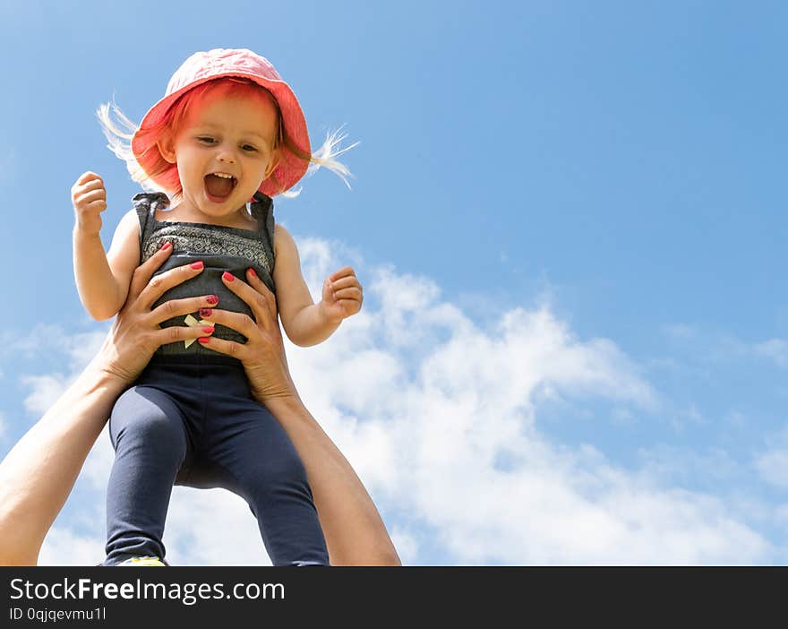 Parent Throws Up a Happy Baby in the Sky. Summer Concept. Parent Throws Up a Happy Baby in the Sky. Summer Concept