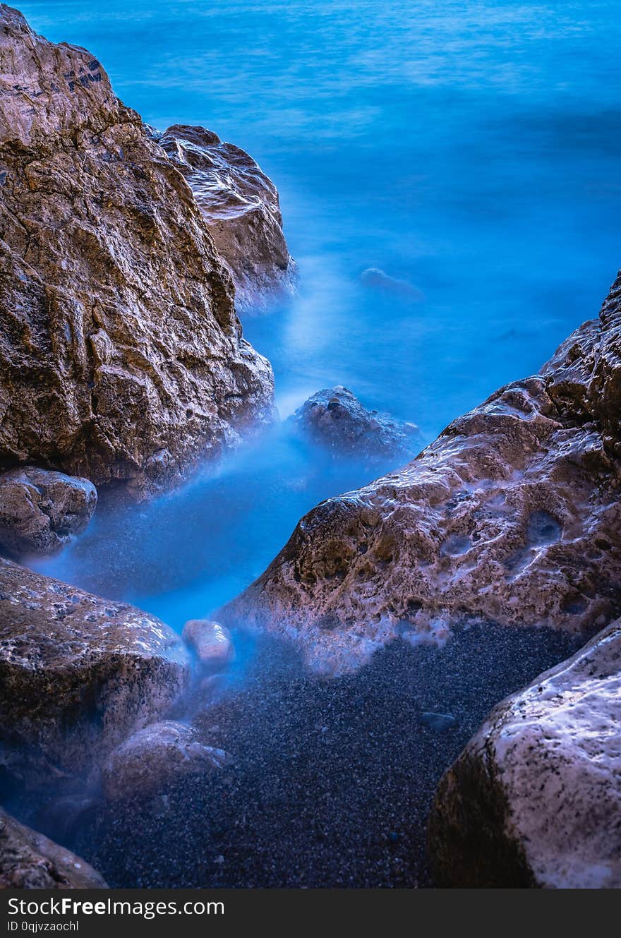 Long exposure image of Dramatic sky seascape with rock in sunset scenery background