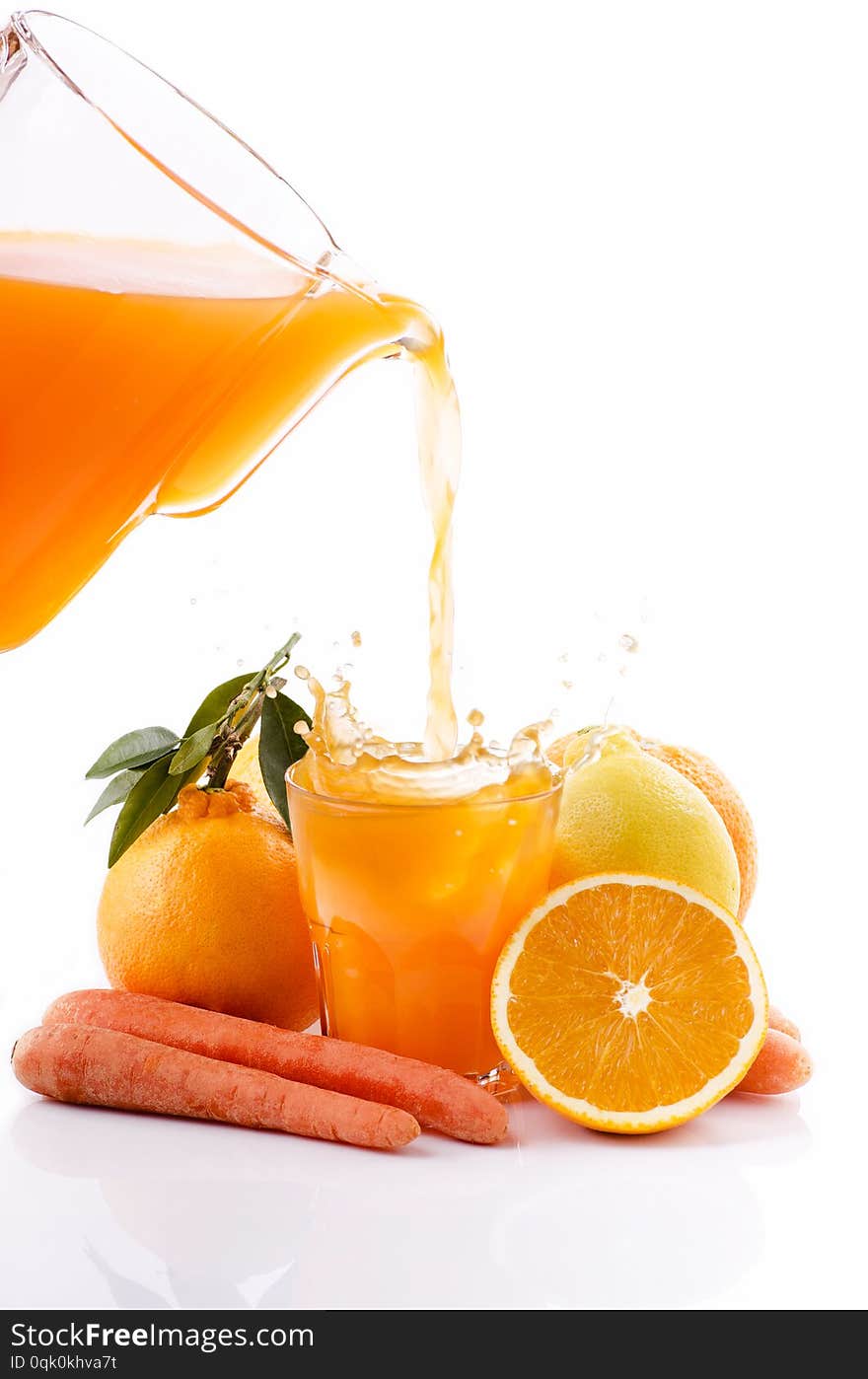 Fresh orange juice with lemon and carrot in the drinking pitcher. Fresh orange juice with lemon and carrot in the drinking pitcher