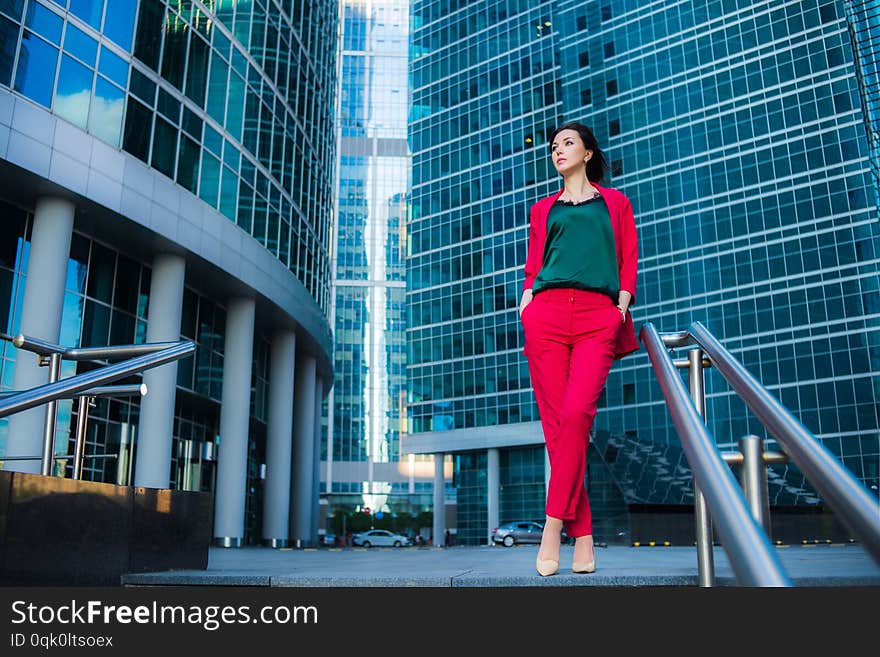 Street fashion business style, attractive model on skyscrapers background. Success concept