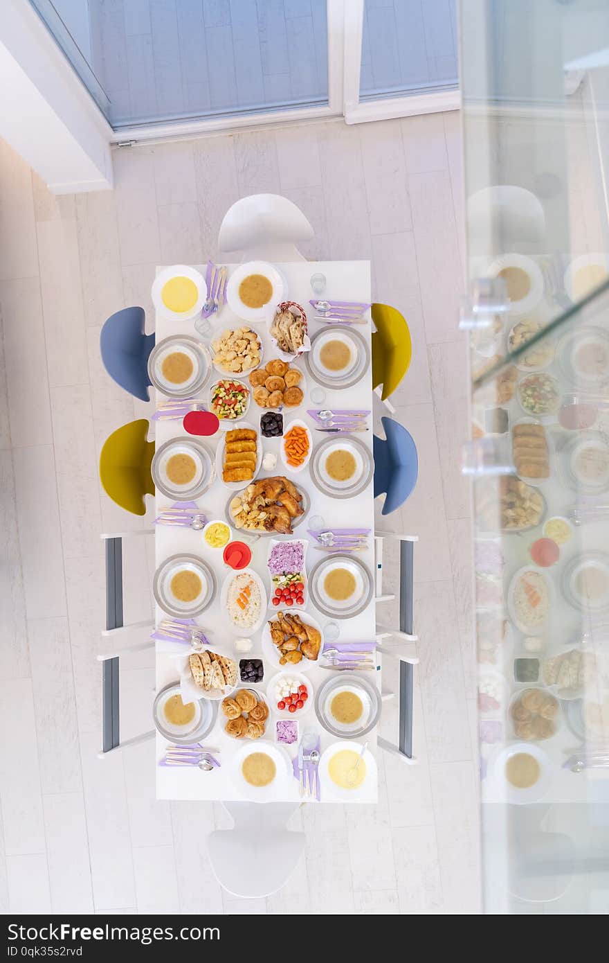 Top view of beautiful decorated and served colorful food for iftar dinner on the white table during ramadan feast at home