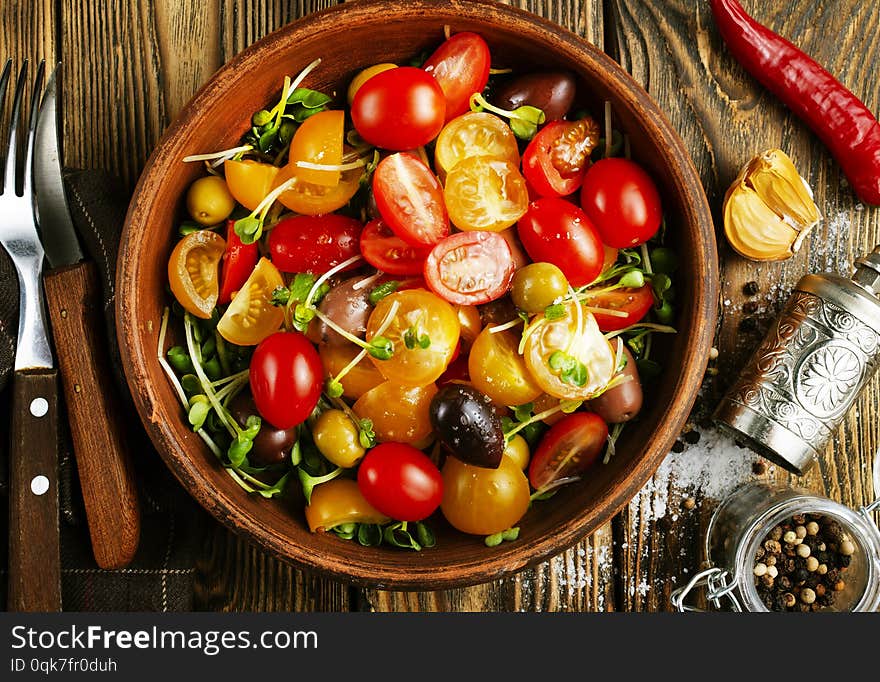 Tomato salad with oil and olives in bowl