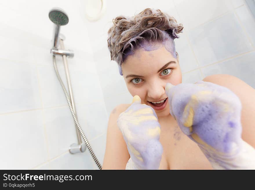 Woman applying toner shampoo on her hair