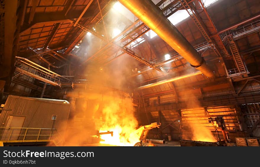 asting ingots in foundry shop, metallurgical production. Melting steel at the plant, heavy industry and dangerous work process. asting ingots in foundry shop, metallurgical production. Melting steel at the plant, heavy industry and dangerous work process.