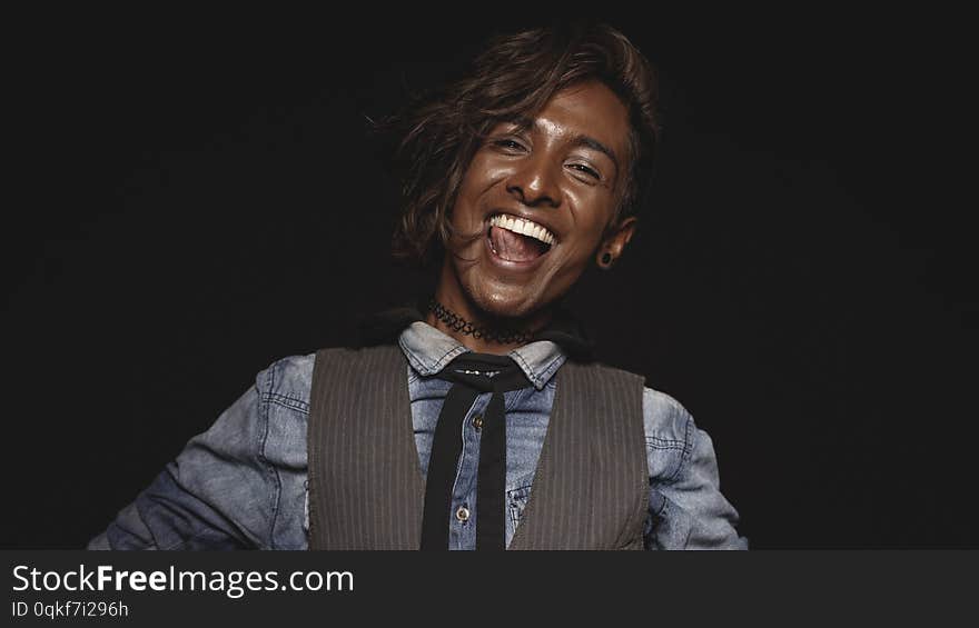 Cheerful african male isolated on black background. Close up of an excited african man looking at camera. Cheerful african male isolated on black background. Close up of an excited african man looking at camera