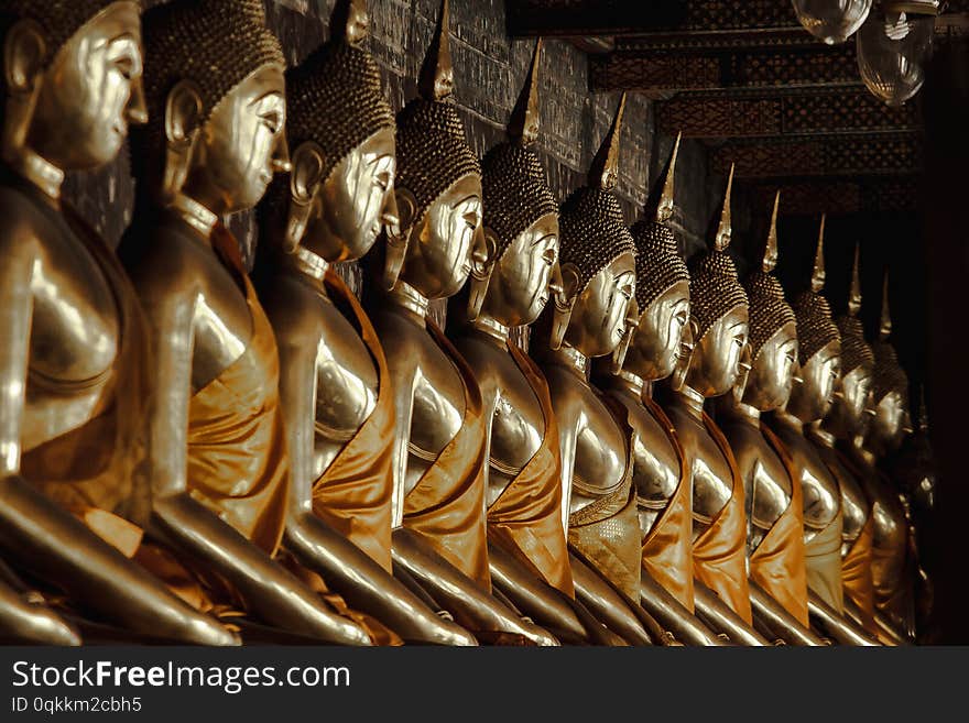 Golden Buddha beside old walls in Thai temples.