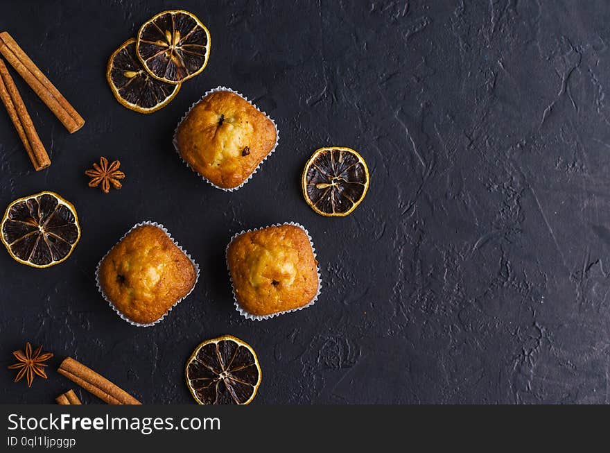 Sweet muffins with on dark textured background.