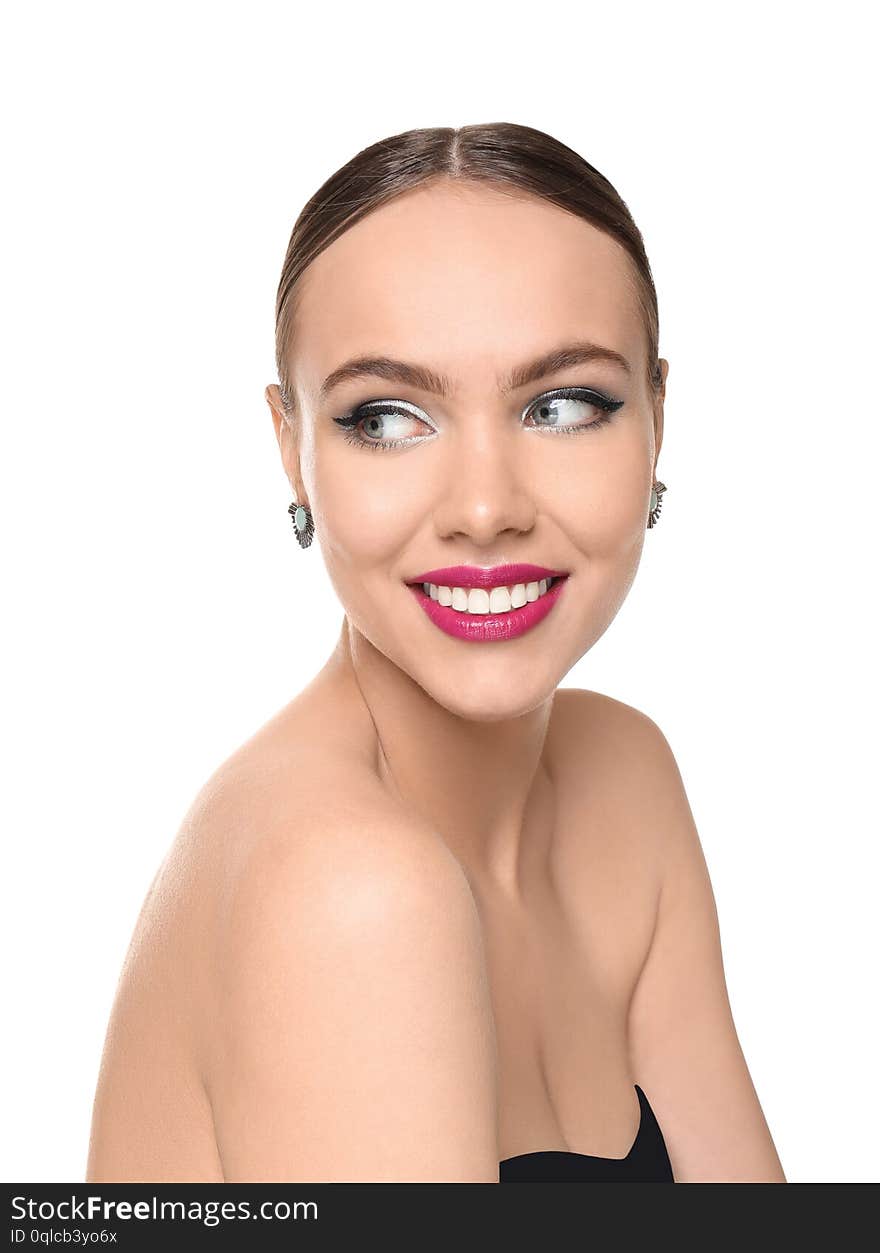 Portrait of young woman with beautiful professional makeup on white background