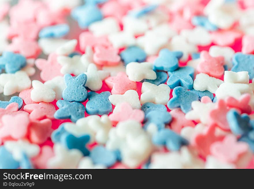 Multicolored candy on a pink background