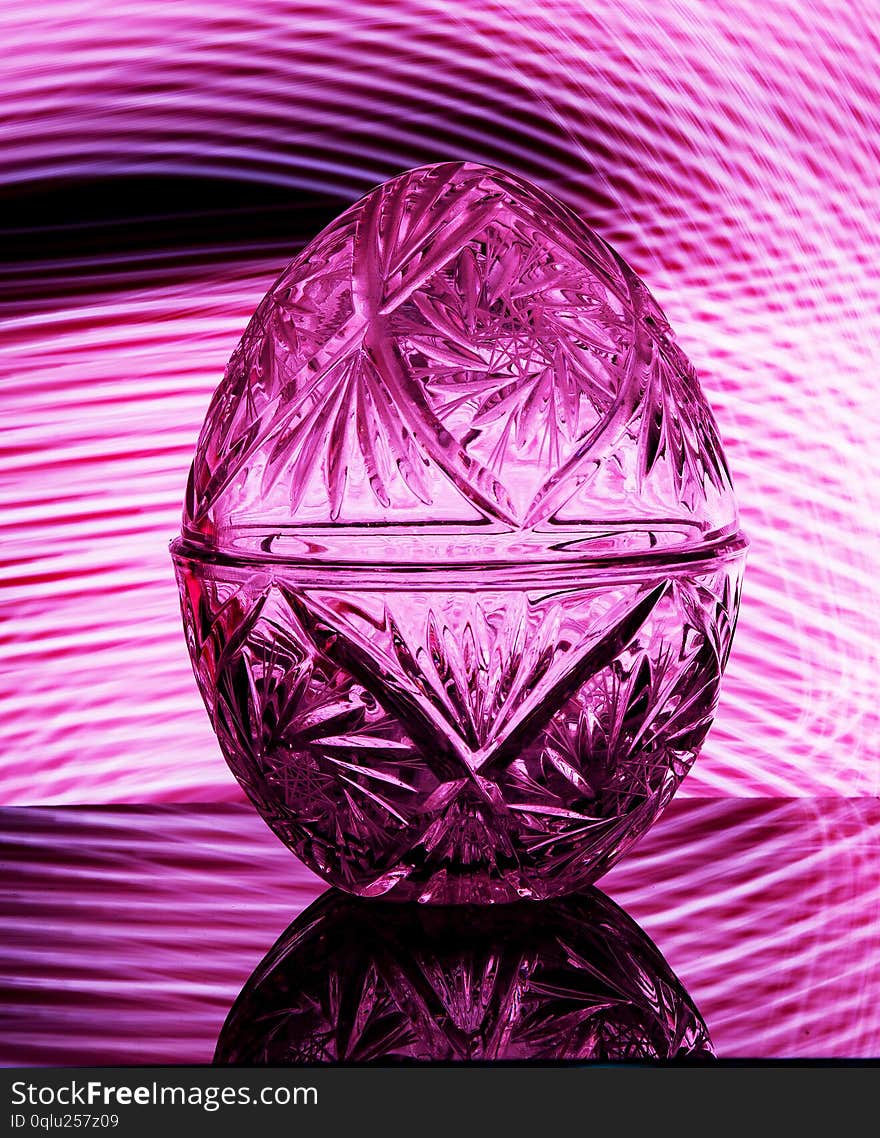 Crystal vase on a black background with pink lighting. Crystal vase on a black background with pink lighting