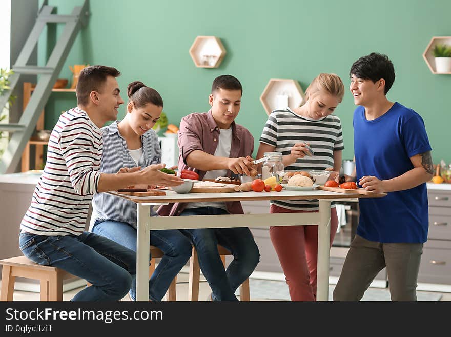 Friends cooking together in kitchen