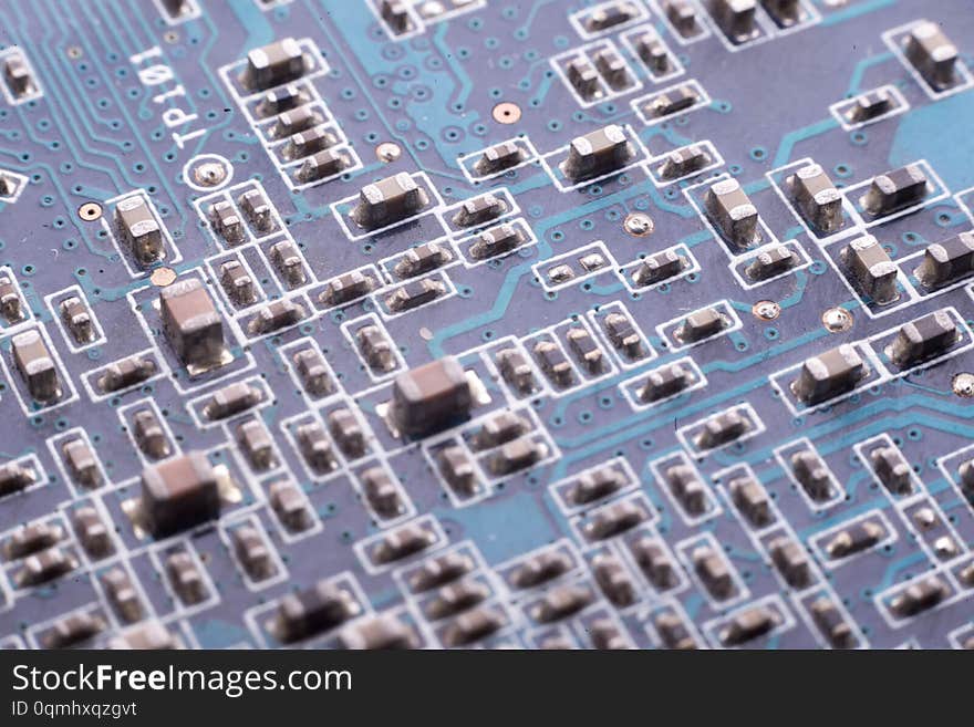 Chips and capacitors on the board. Board blue. Close-up shot. Macro photography electronics