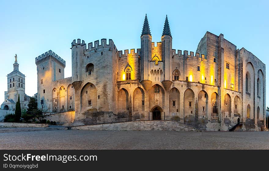 Panorama of the building of the famous medieval papal palace at dawn. Avignon. France. Panorama of the building of the famous medieval papal palace at dawn. Avignon. France.
