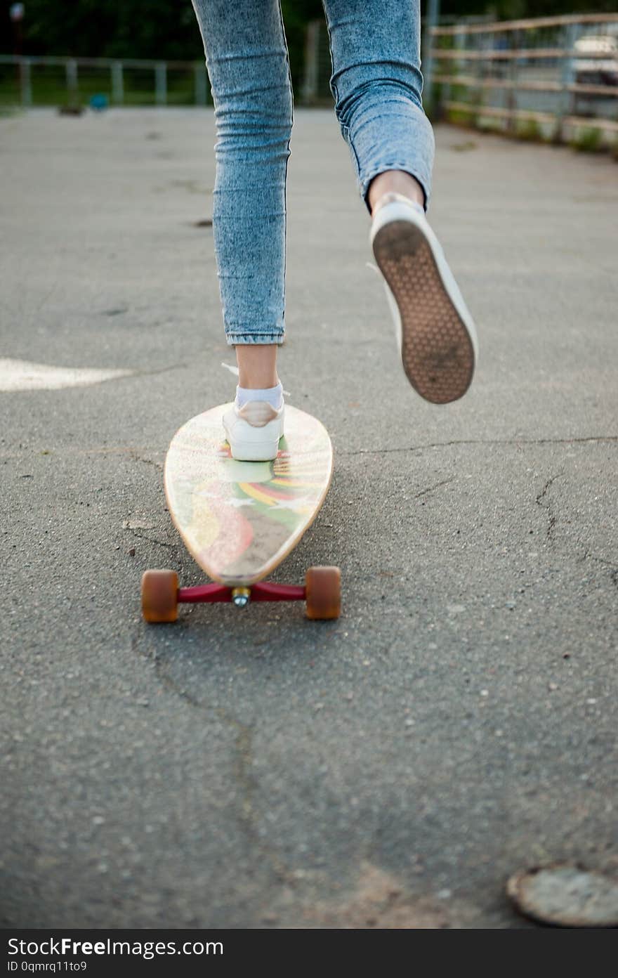 Girl with longboard wearing sneakers shoes in urban style