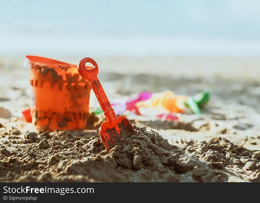 Plastic toys on sandy beach