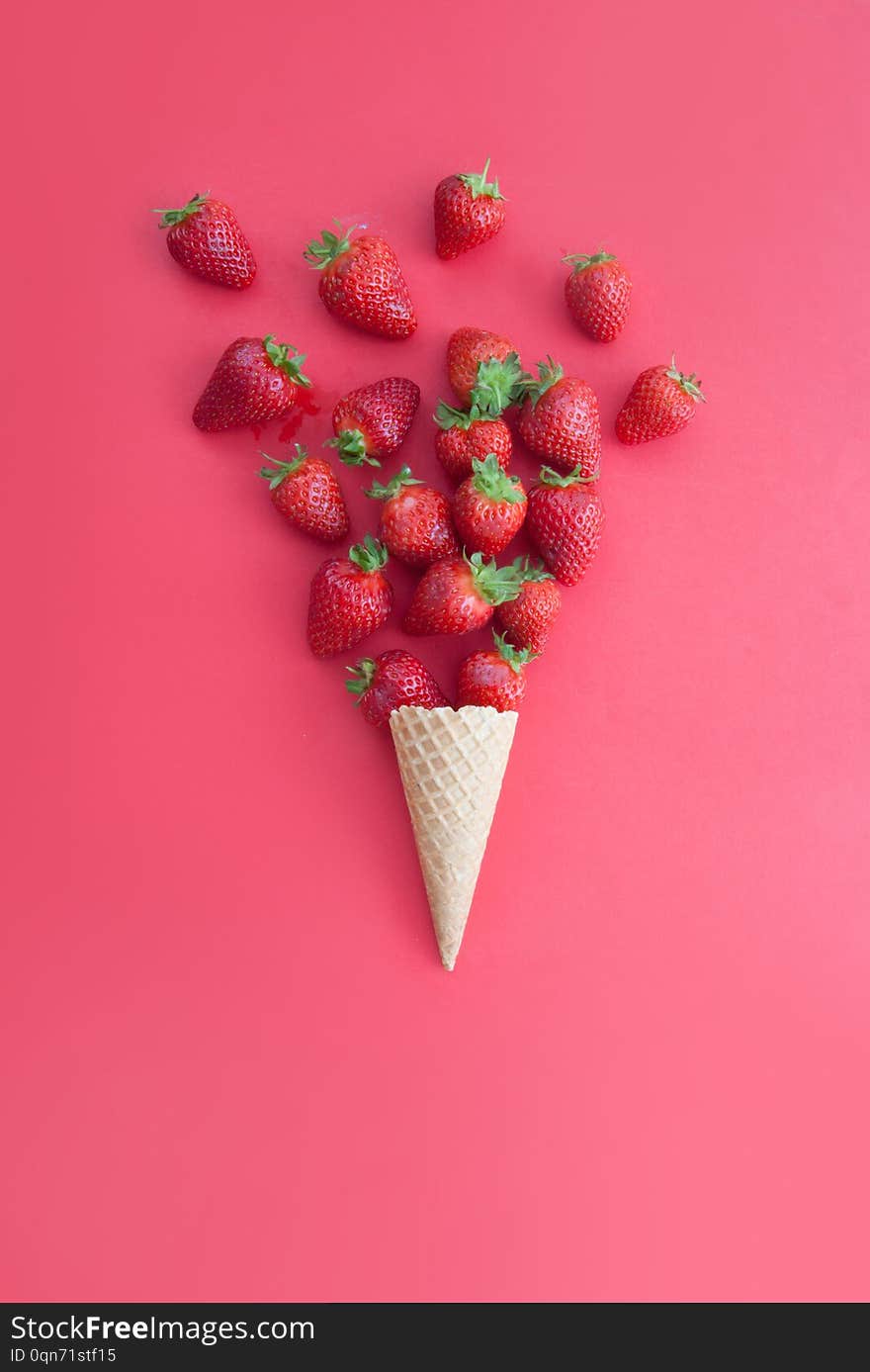 Strawberries falling out of an ice cream cone. Strawberries falling out of an ice cream cone