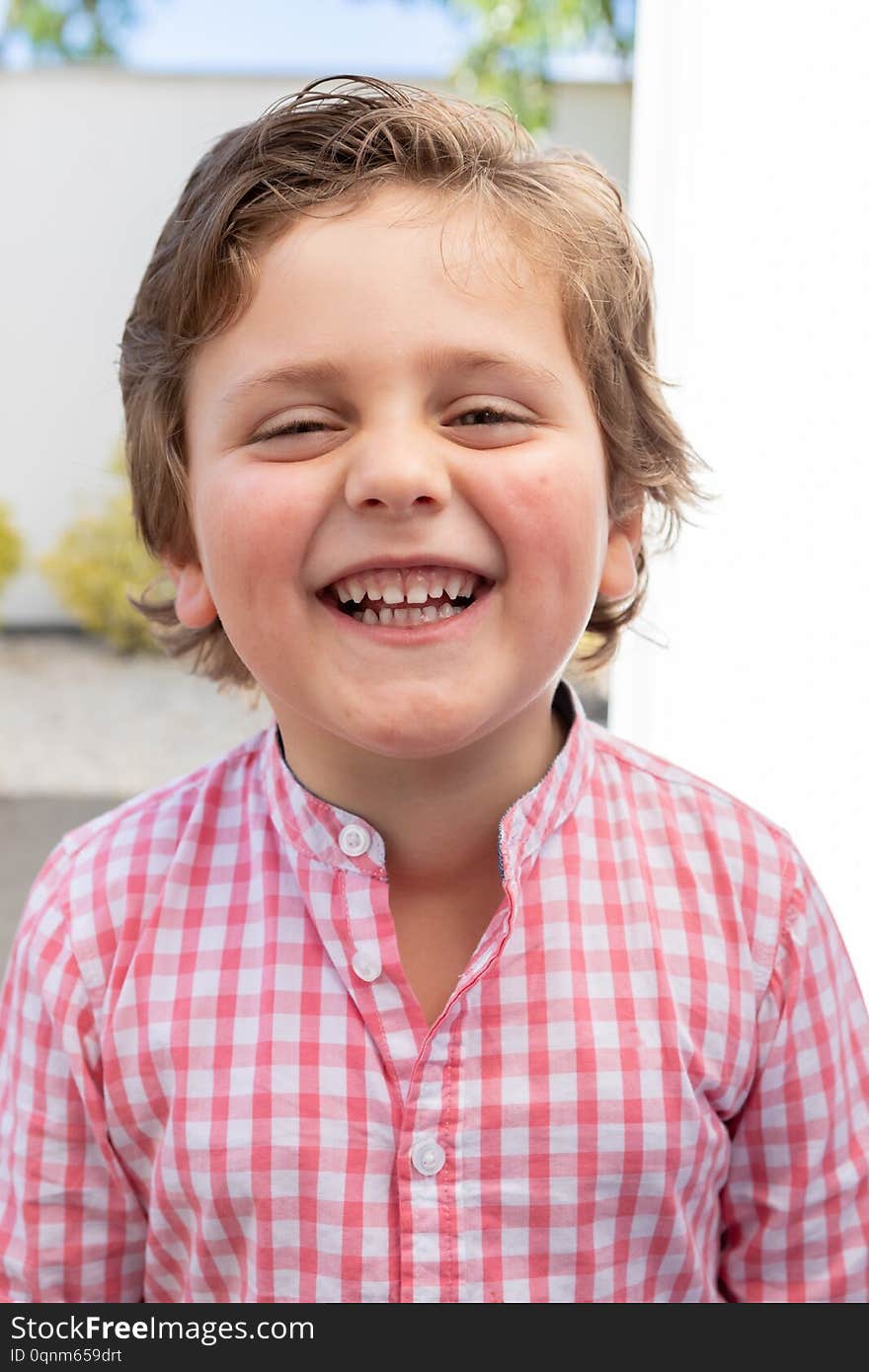 Happy Child With Pink Shirt In The Garden