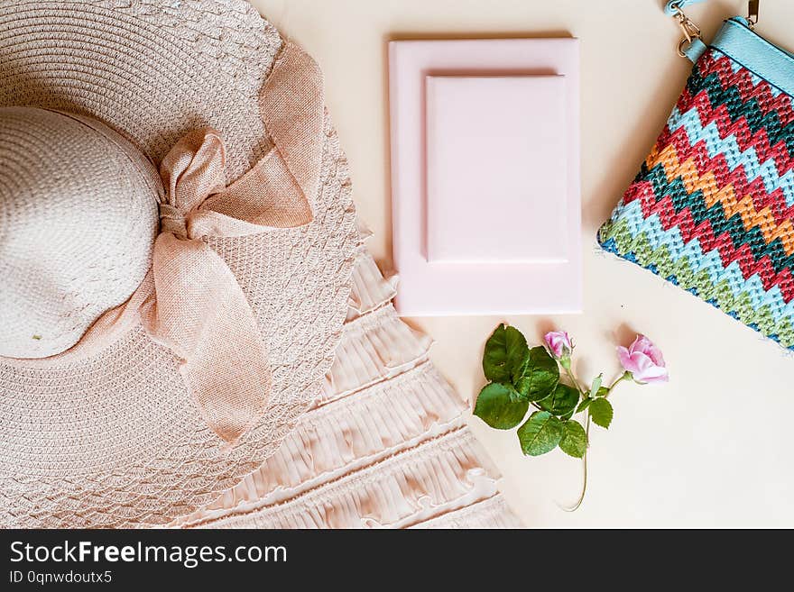 Summer street style. Fashion girl clothes accessories. Trendy top, handbag clutch, necklace hat, flowers. Creative urban