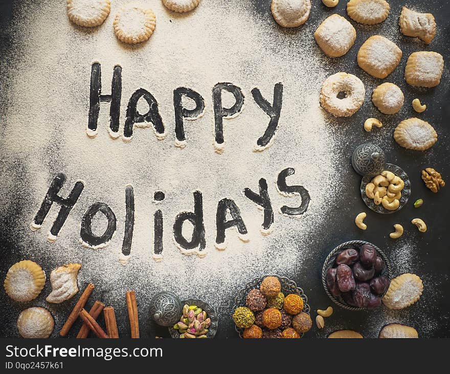 Happy Holidays Food Background. Arab Sweets Are Laid Out On A Black Table.