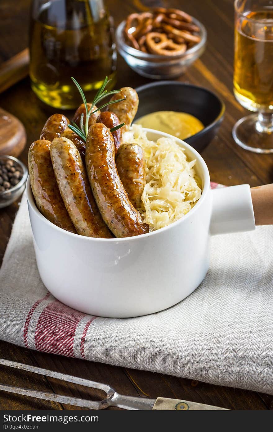 Traditional German Sausages with Cabbage Salad, Mustard and Beer. Bratwurst and Sauerkraut.