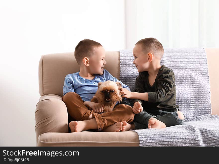 Portrait of cute boys with funny Brussels Griffon dog at home