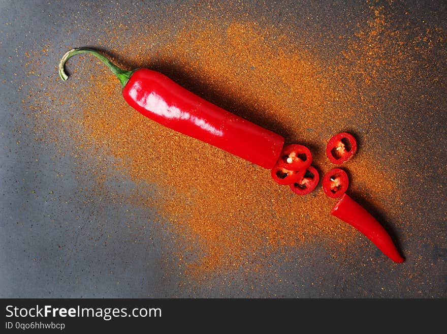 Red Chili Pepper At Dark Background With Paprika Powder