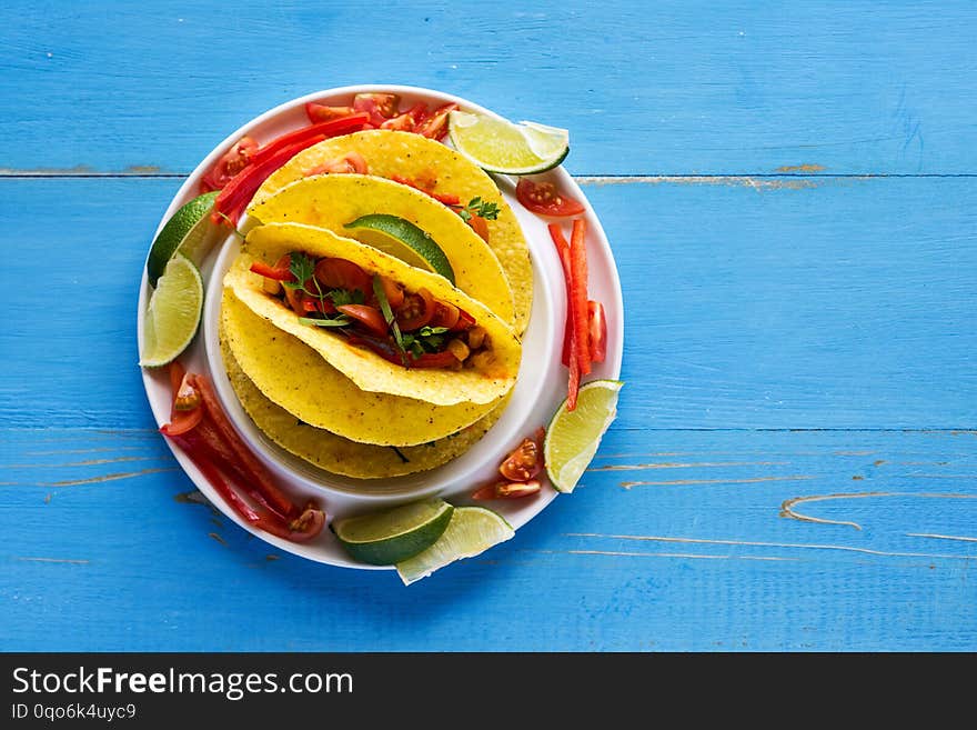 Healthy Mexican Tacos with Ground Beef and Vegetables on Rustic Blue Background