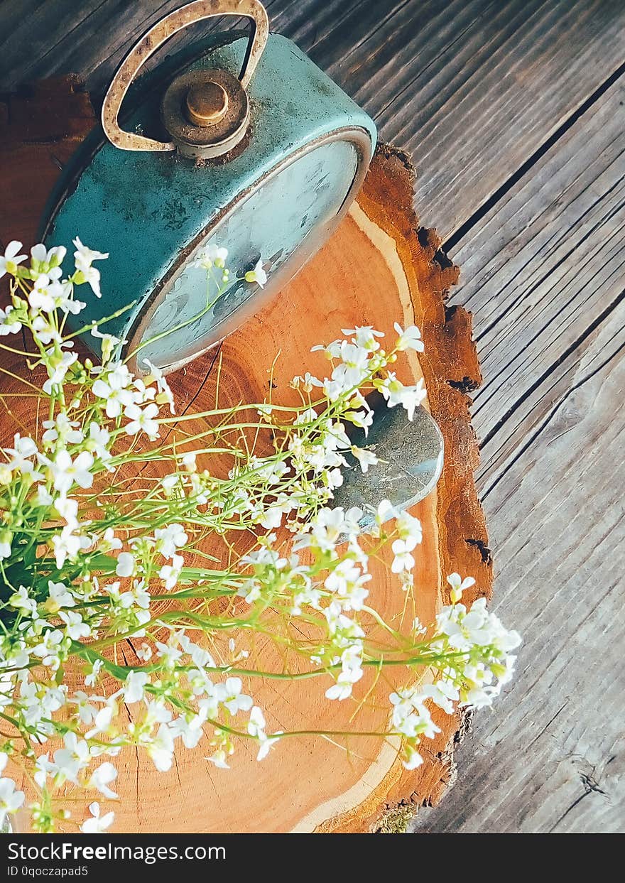 Wild fresh flowers in porcelain jug, old clock on blue wooden background. Daylight, vivid colors. Still life in rustic style. Countryside lifestyle, holiday, vacation concept. Selective focus Top view. Wild fresh flowers in porcelain jug, old clock on blue wooden background. Daylight, vivid colors. Still life in rustic style. Countryside lifestyle, holiday, vacation concept. Selective focus Top view