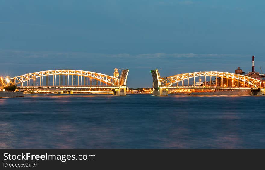 Bolsheokhtinsky bridge in St. Petersburg at night with open spans over the Neva