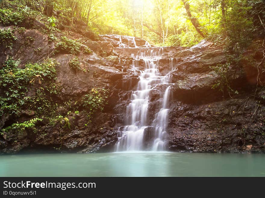 beautiful small waterfall in the wild with sun light,nature