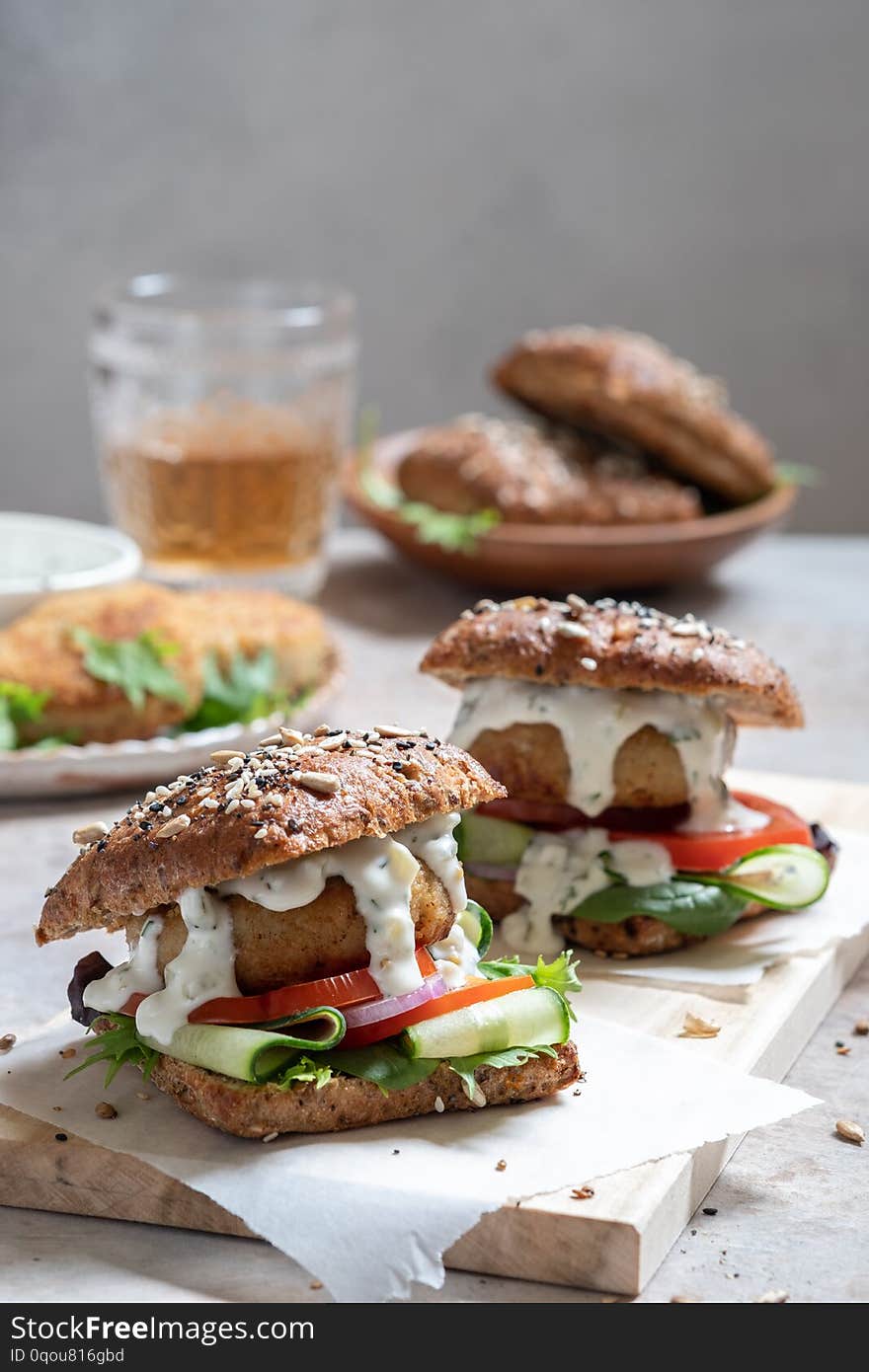 Fish seafood burger with mayo and fresh vegetables