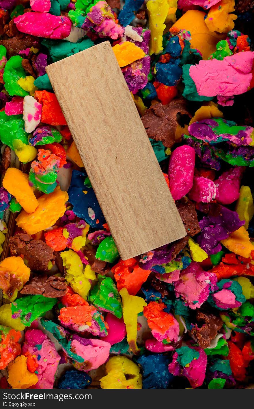 Piece of wood on dried colorful play dough