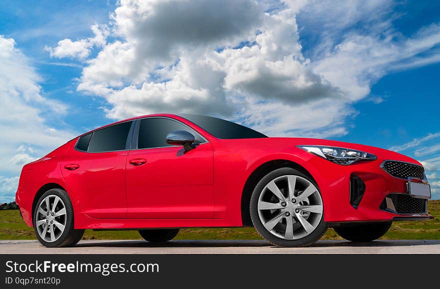 Red car on a blue sky background.