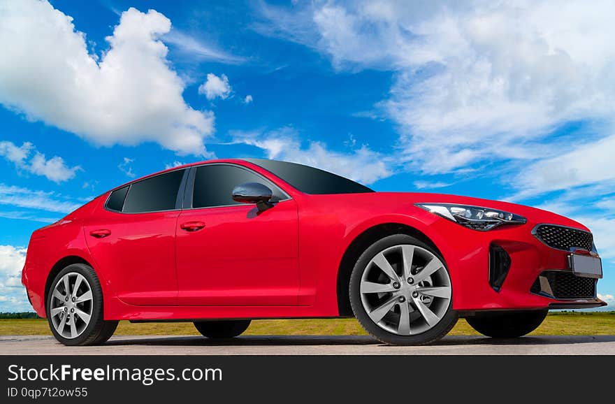 Red Car On A Blue Sky Background.