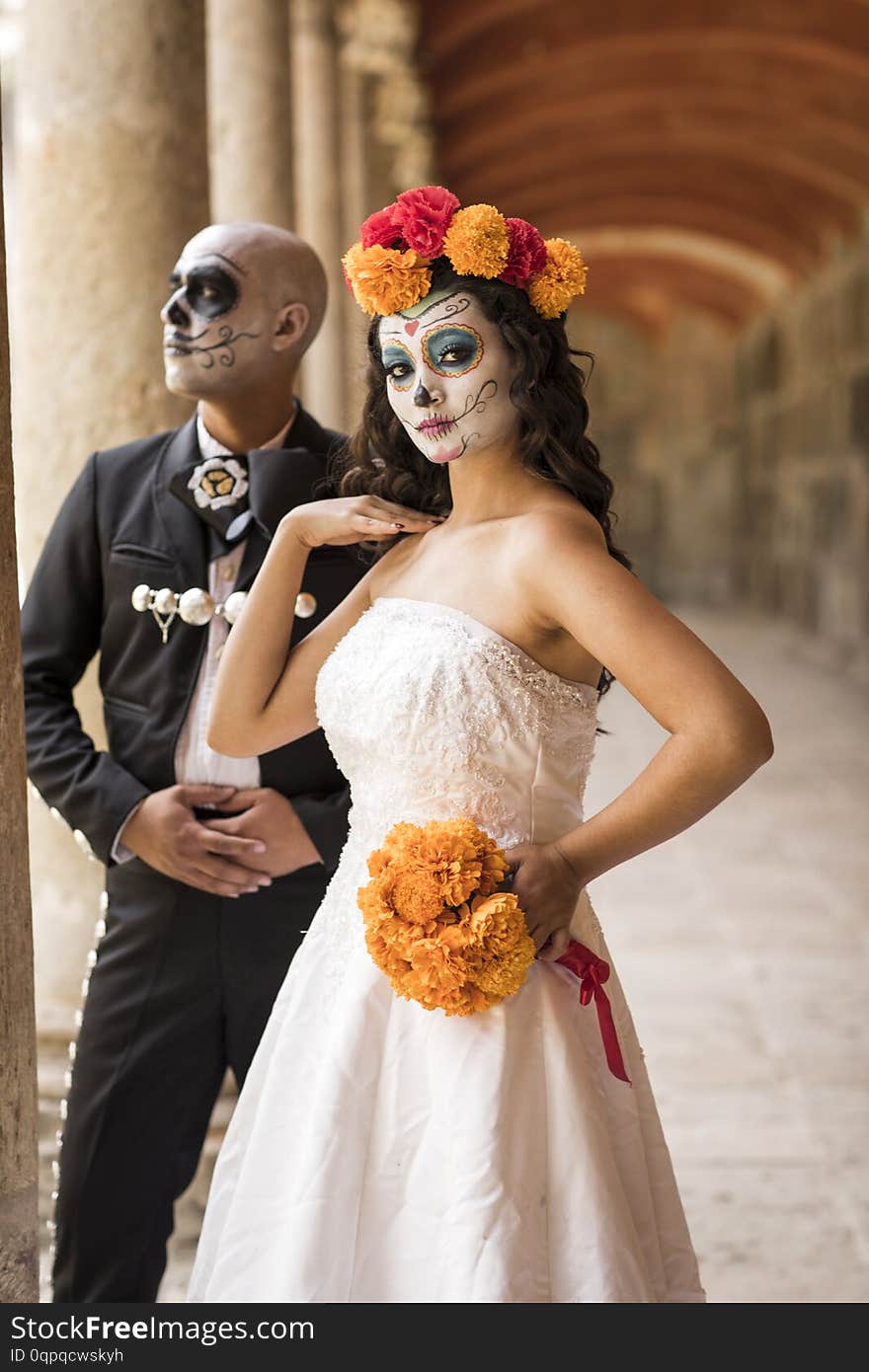 Catrin and Catrina in cemetery with wedding dresses in an old cemetery of Guadalajara, Mexico