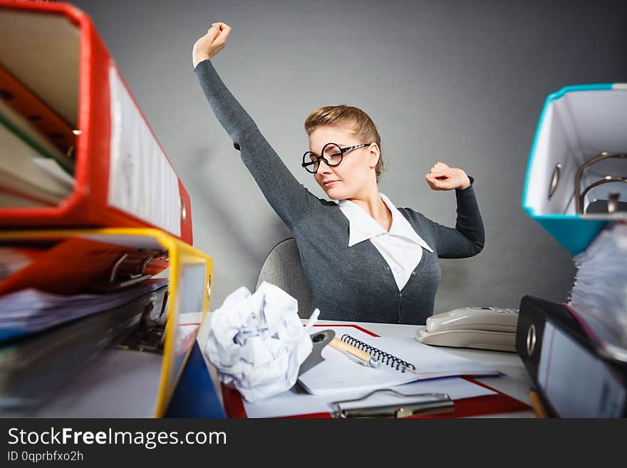 Boredom and fatigue concept. Young emotional expressive woman in office. Bored tired businesswoman yawning stretching at work. Boredom and fatigue concept. Young emotional expressive woman in office. Bored tired businesswoman yawning stretching at work