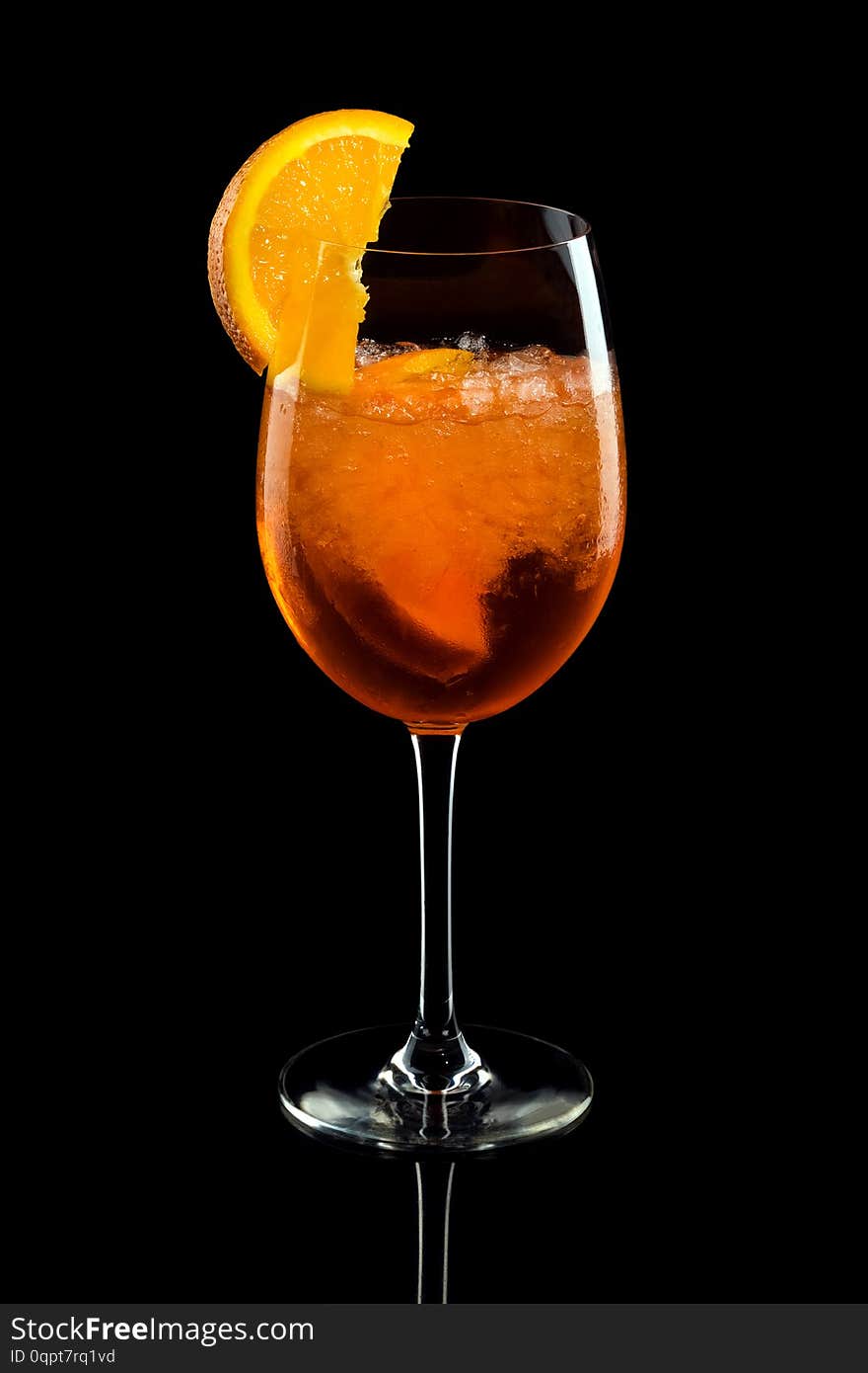 Aperol syringe in glass with orange, summer cocktail over black background. Aperol syringe in glass with orange, summer cocktail over black background