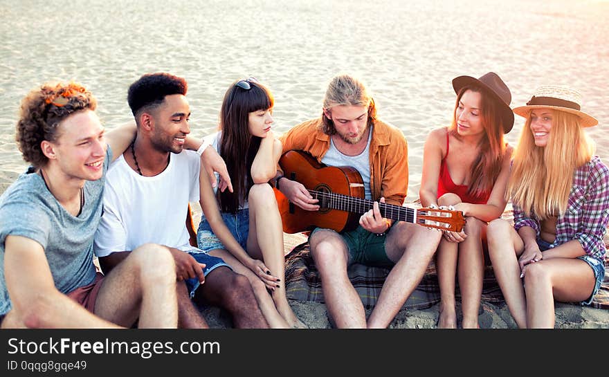 Happy group of friend having party on the beach.