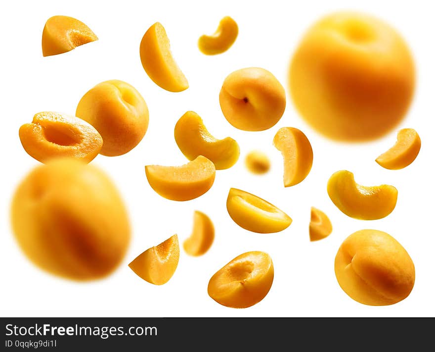 Apricots levitate on a white background. Ripe fruit in flight