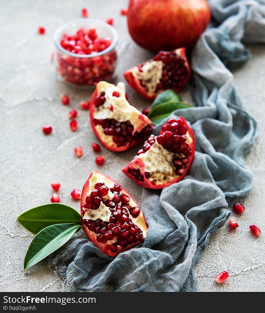 Ripe pomegranate fruits on  grey concrete background