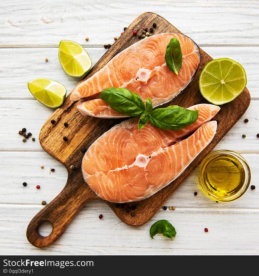 Raw salmon steaks and ingredients on a old wooden table