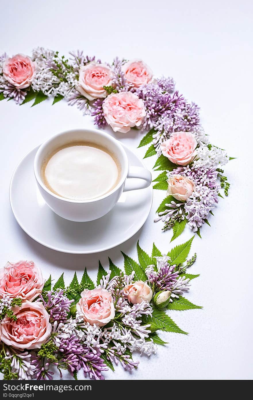 Vertical web banner. Frame of flowers: rose, lilac, rowan leaves and cup coffee on a white background. Floral pattern