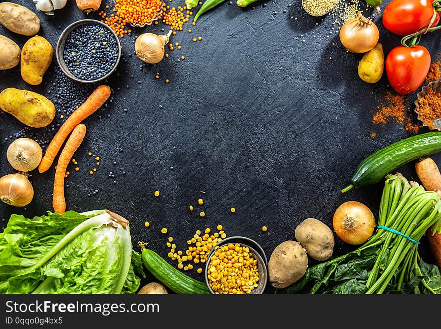 Healthy food background. Tasty variety of different vegetables on dark background. Flat Lay. Healthy Eating Vegan Vegetarian Concept. Copy Space. Healthy food background. Tasty variety of different vegetables on dark background. Flat Lay. Healthy Eating Vegan Vegetarian Concept. Copy Space