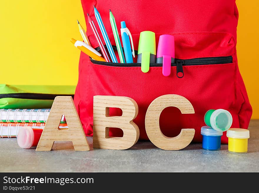 School supplies on grey table against color background, space for text