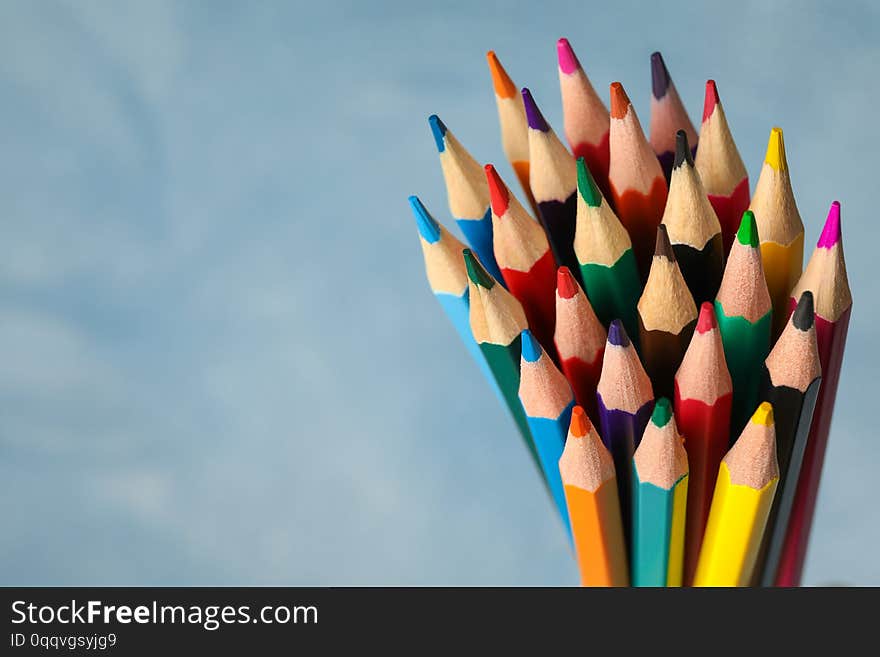 Multicolored Pencils Against Light Blue Background