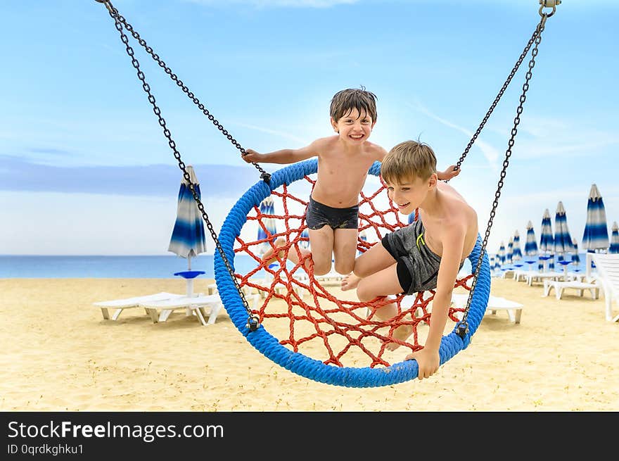 Kds Swinging On Beach