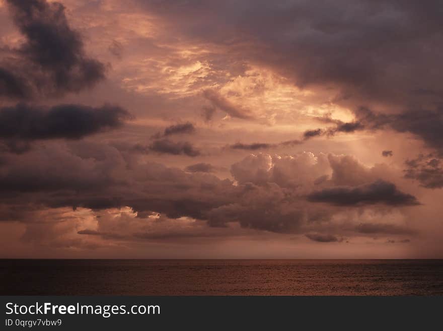 Sunset sky on the Carribean Sea at Cuba, red clouds and sea skyline. Sunset sky on the Carribean Sea at Cuba, red clouds and sea skyline